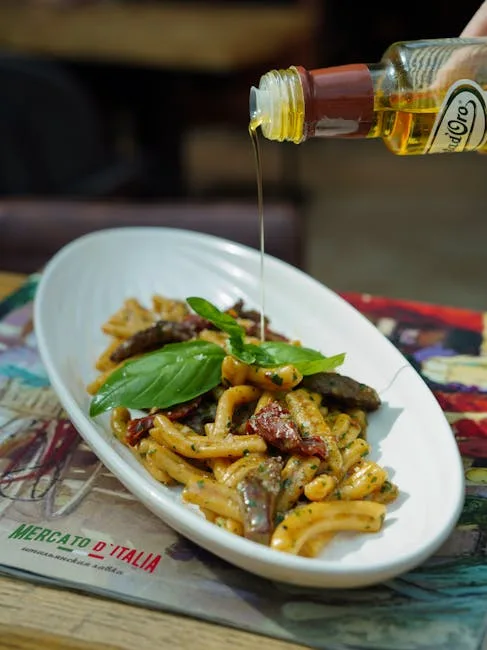 Extra virgin olive oil being poured over pasta dish at a Lecce restaurant