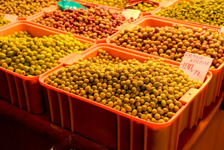 Plastic crates of assorted green and marinated olives at Lecce market