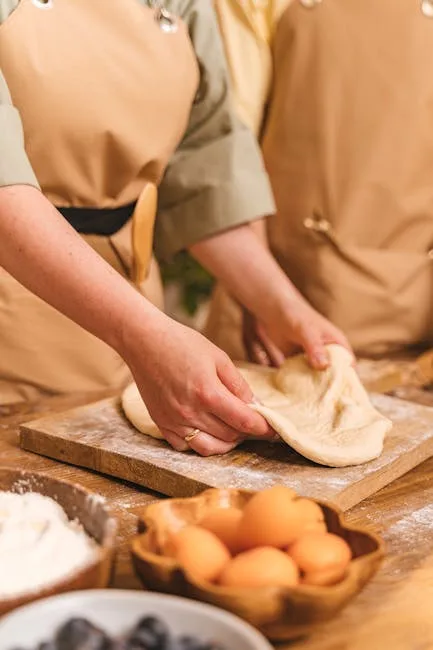 Hands stretching dough on wooden board during a Lecce cooking class