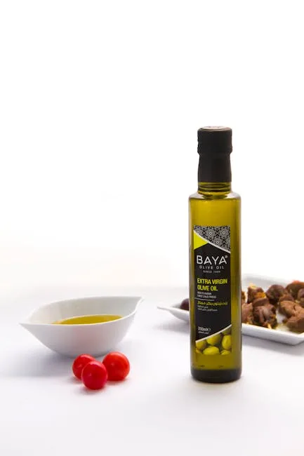 Bottle of extra virgin olive oil with tasting bowl and tomatoes in Lecce