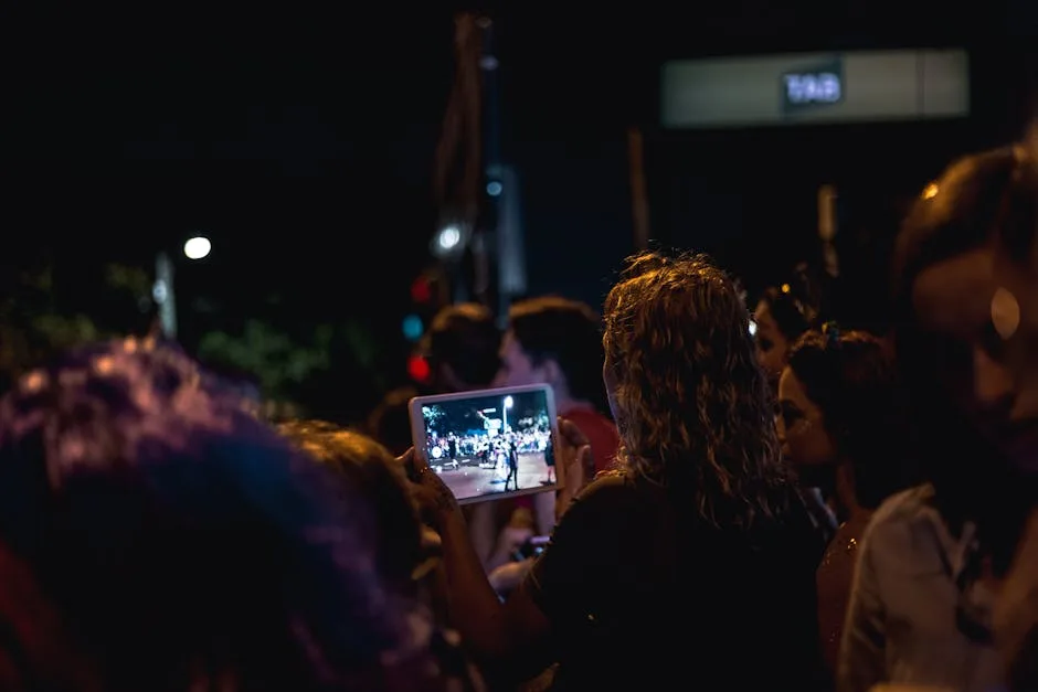 Night crowd filming the festival concert in Lecce on a tablet