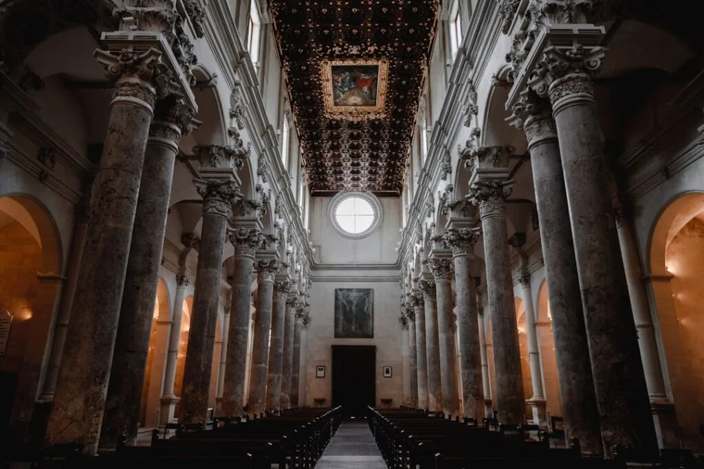 Photographer tripod inside Lecce church low light