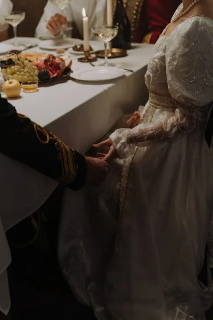 Candlelit dinner scene with hands clasped beside elegantly set table