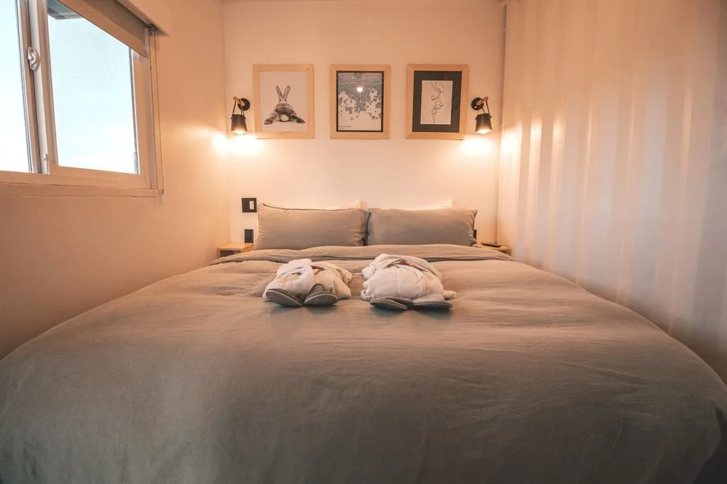Cozy hotel bedroom in Lecce with neatly made bed and robes