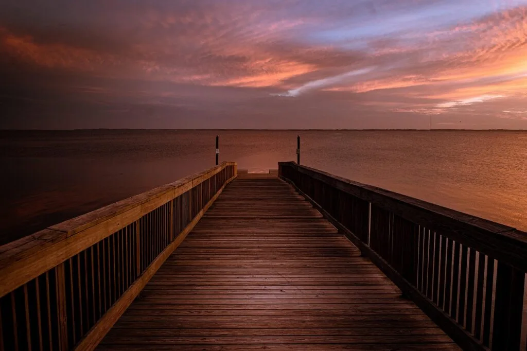 Wooden jetty at sunset, calm sea near Lecce